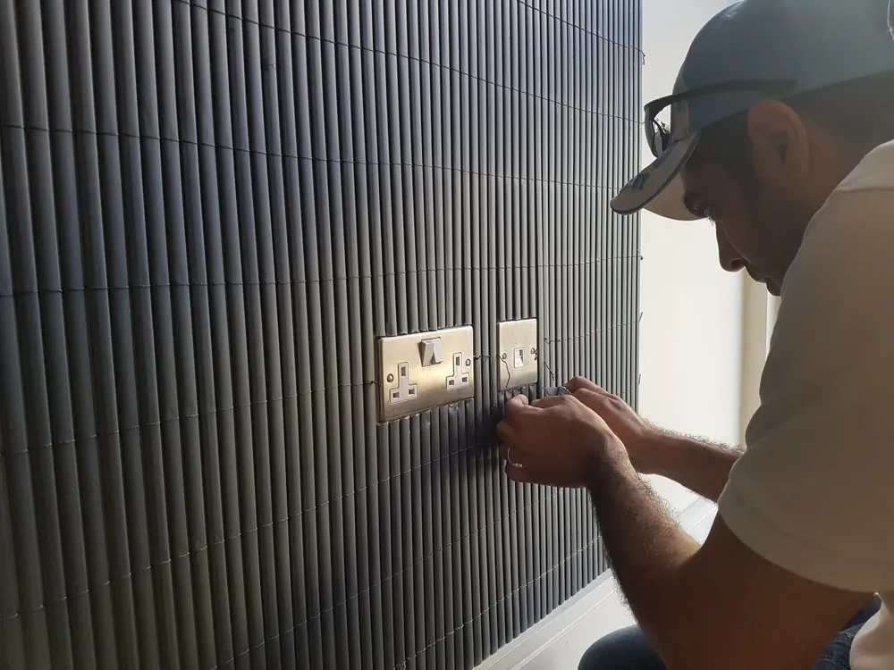 Slat wall and socket detail, finished by Omar Decor
